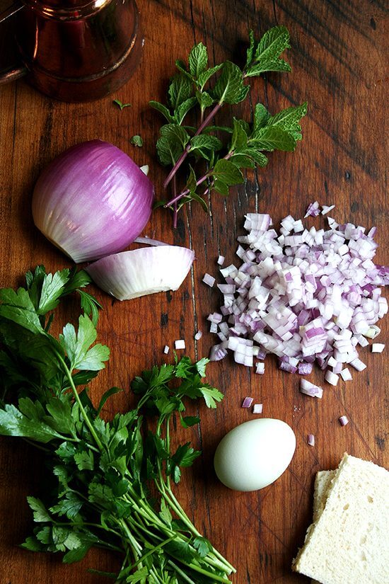 ingredients A board with mint and diced red onion.