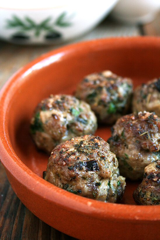 Lamb meatballs, loaded with mint and parsley, broiled, sprinkled with vinegar, and served with roasted cabbage, are perfect for Easter. // www.simonrockett.com Lamb meatballs, loaded with mint and parsley, broiled, sprinkled with vinegar in a small plate.