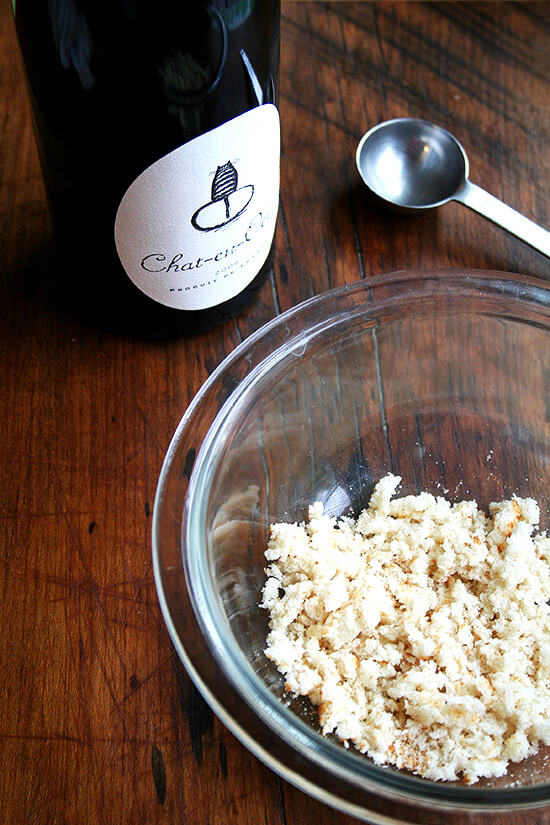 wine and bread A bowl of ground bread aside a bottle of red wine.