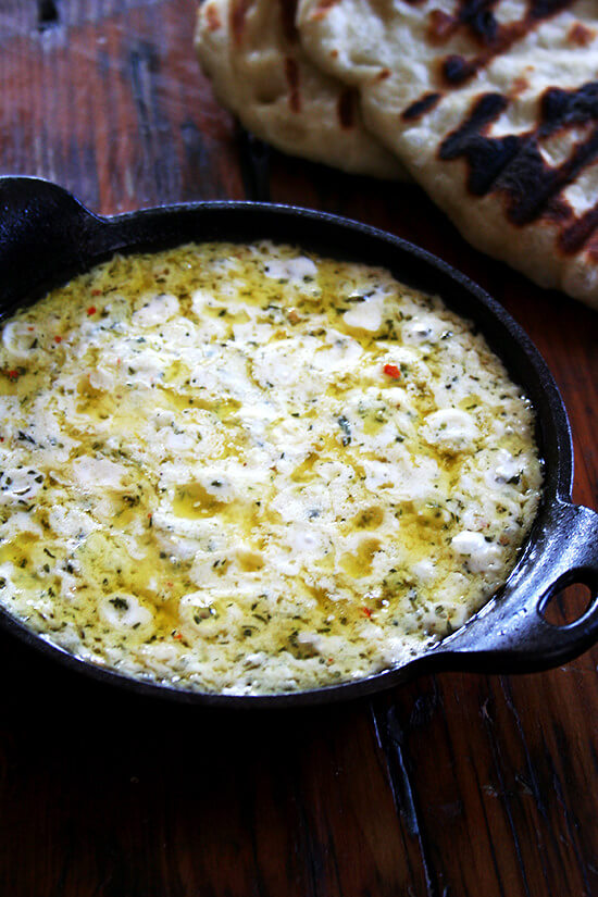 As is the case with so many baked cheese dips, the success of this baked ricotta can be attributed to the synergistic reaction that takes place in the oven, the final melty product amounting to so much more than the sum of its herbs, spices, and cheeses. In other words: cheese is good, melted cheese is better. // www.simonrockett.com 就像许多烤奶酪蘸酱一样,这款烤乳清干酪的成功可以归因于烤箱中发生的协同反应,最终融化的产品远远超过香草、香料和奶酪的总和。换句话说:奶酪很好,融化的奶酪更好。/ / www.simonrockett.com