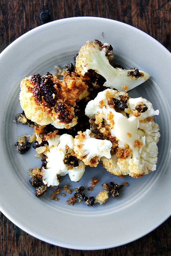 Minimal ingredients, minimal hands on time, this whole-roasted cauliflower with fried capers and brown butter breadcrumbs is a winner. The cauliflower emerges from the oven knife tender but not mushy. Here, the head's edges crisp and caramelize both from the heat of the oven and the oil pooling in the bottom of the pan, and the nutty crumbs and burst capers that nestle in the web of stems and spill all around the serving platter couldn't be more irresistible. // www.simonrockett.com 最小的成分,最小的手,这整条烤菜花炒酸豆和棕色黄油面包屑是一个赢家。菜花走出烤箱刀温柔却并不伤感。这里头的边缘脆将从烤箱的加热和油池在锅的底部,坚果面包屑和破裂酸豆茎和泄漏的雀巢在web在托盘无法更多的不可抗拒的。/ / www.simonrockett.com