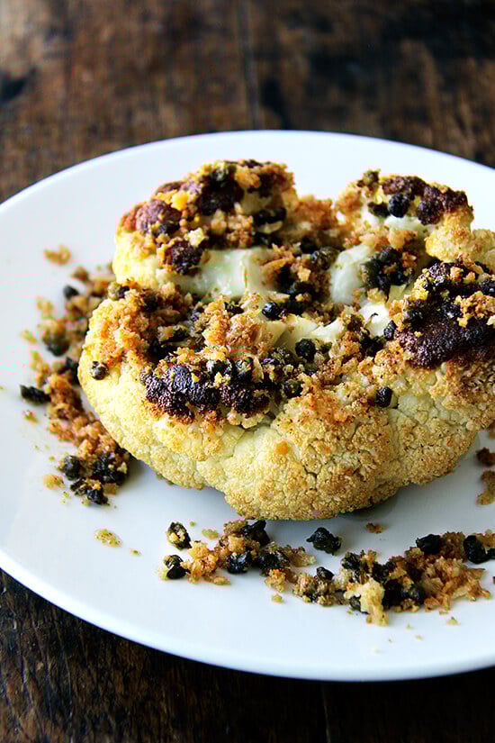 Minimal ingredients, minimal hands on time, this whole-roasted cauliflower with fried capers and brown butter breadcrumbs is a winner. The cauliflower emerges from the oven knife tender but not mushy. Here, the head's edges crisp and caramelize both from the heat of the oven and the oil pooling in the bottom of the pan, and the nutty crumbs and burst capers that nestle in the web of stems and spill all around the serving platter couldn't be more irresistible. // www.simonrockett.com 最小的成分,最小的手,这整条烤菜花炒酸豆和棕色黄油面包屑是一个赢家。菜花走出烤箱刀温柔却并不伤感。这里头的边缘脆将从烤箱的加热和油池在锅的底部,坚果面包屑和破裂酸豆茎和泄漏的雀巢在web在托盘无法更多的不可抗拒的。/ / www.simonrockett.com