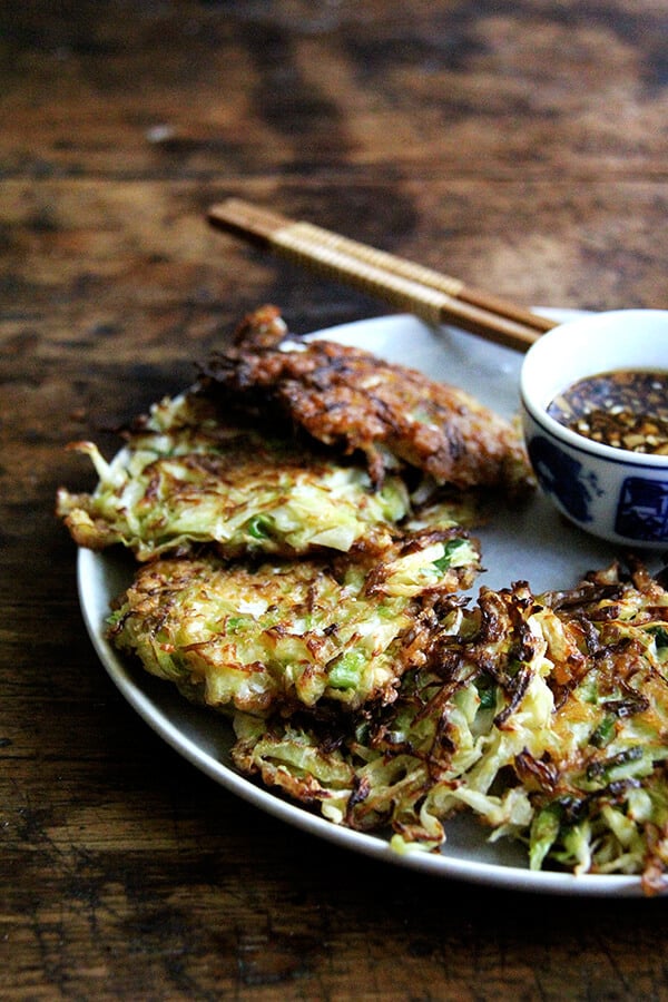 Okonomiyaki, Japanese cabbage pancakes, can be made in countless ways: okonomiyaki essentially means prepared as you like. This my favorite version I've made yet, but know that you can add to it as you like with shrimp or chicken, sesame seeds or bonito flakes, other vegetables, etc. I prefer a soy-based dipping sauce to the more traditional mayonnaise-based, and, like the corn fritters, find these as irresistible freshly fried as cold straight from the fridge. // www.simonrockett.com 御好烧的盘。
