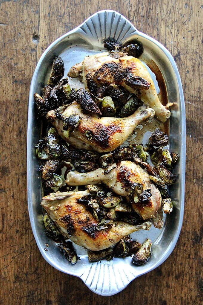 In this roast chicken with Brussels sprouts recipe, after roasting chicken legs, the emptied pan gets hit with a few tablespoons of syrupy balsamic vinegar, which not only deglazes it, but also provides that bite so often welcomed by the cabbage family of vegetables. // www.simonrockett.com 一盘烤盘烤鸡和香蒜球芽甘蓝。