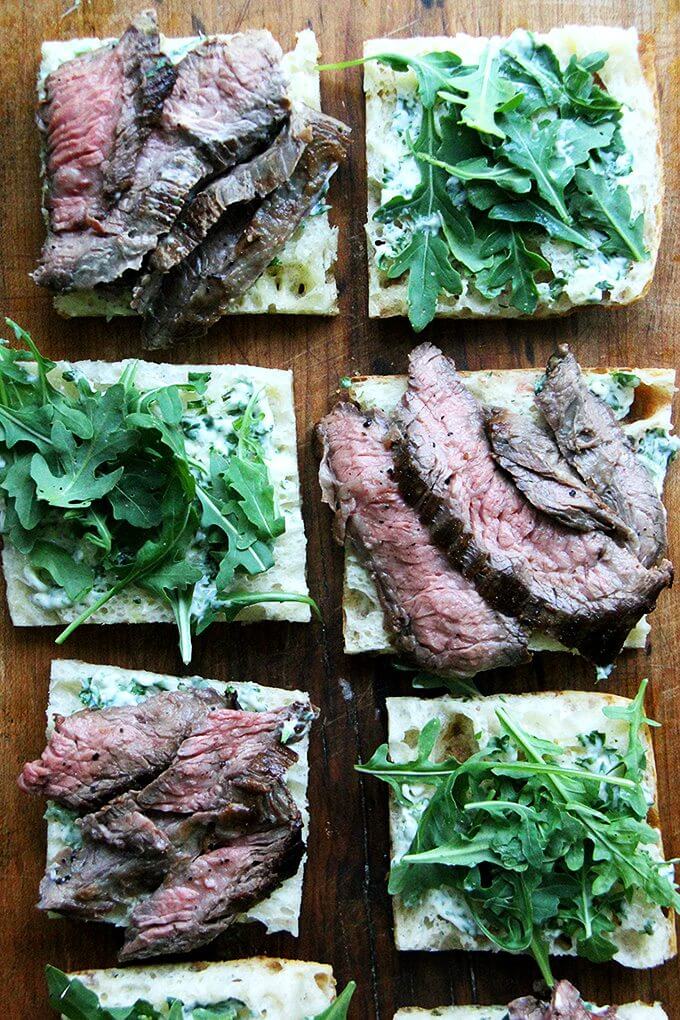 In these skirt steak sandwiches, skirt steak, which cooks to medium-rare in just about 5 minutes, is layered with arugula between slices of focaccia smeared with herbed mayonnaise. The key, as with all meats, is to let the steak rest for at least 10 minutes before slicing, and with skirt steak, to slice it thinly against the grain. // www.simonrockett.com In these skirt steak sandwiches, skirt steak, which cooks to medium-rare in just about 5 minutes, is layered with arugula between slices of focaccia smeared with herbed mayonnaise. The key, as with all meats, is to let the steak rest for at least 10 minutes before slicing, and with skirt steak, to slice it thinly against the grain. // www.simonrockett.com