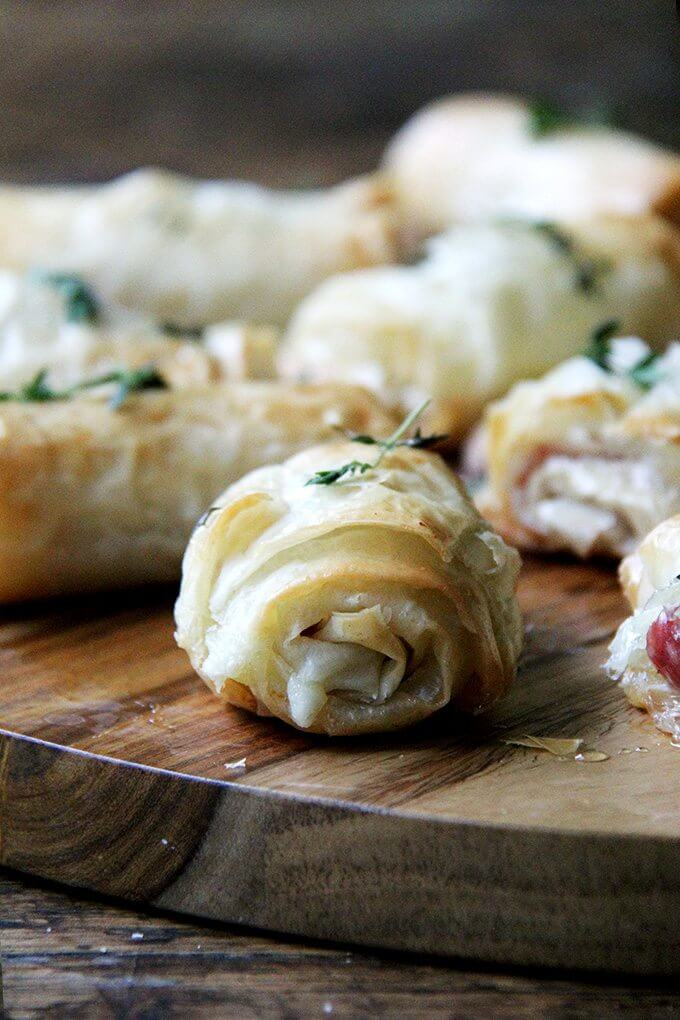 Hit with a drizzle of honey out of the oven, these salty-sweet, flaky salami and provolone phyllo rolls are irresistible. You can also assemble them ahead of time and stash them in the fridge or freezer until needed. // www.simonrockett.com 近距离射击的香肠和波萝伏洛干酪蛋糕卷。