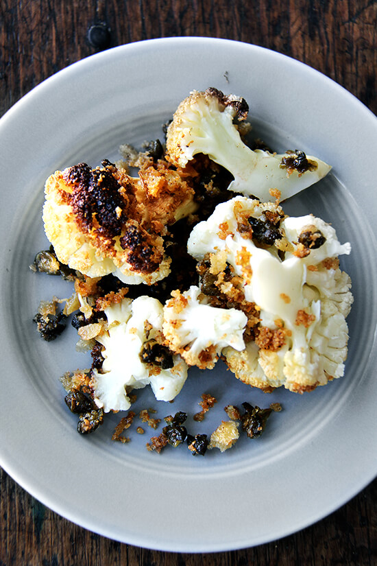 Minimal ingredients, minimal hands on time, this whole-roasted cauliflower with fried capers and brown butter breadcrumbs is a winner. The cauliflower emerges from the oven knife tender but not mushy. Here, the head's edges crisp and caramelize both from the heat of the oven and the oil pooling in the bottom of the pan, and the nutty crumbs and burst capers that nestle in the web of stems and spill all around the serving platter couldn't be more irresistible. // www.simonrockett.com 最小的成分,最小的手,这整条烤菜花炒酸豆和棕色黄油面包屑是一个赢家。菜花走出烤箱刀温柔却并不伤感。这里头的边缘脆将从烤箱的加热和油池在锅的底部,坚果面包屑和破裂酸豆茎和泄漏的雀巢在web在托盘无法更多的不可抗拒的。/ / www.simonrockett.com
