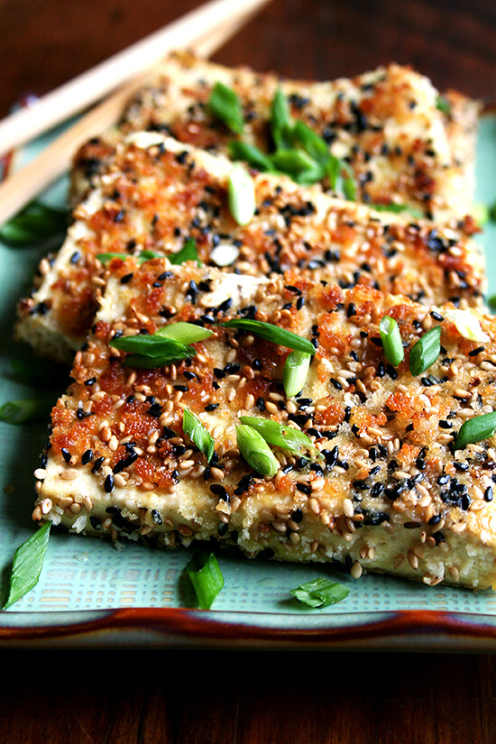 This baked tofu has a simple preparation, which calls for making a four-ingredient dressing, and results in nicely textured and completely tasty tofu—crispy edges, custardy centers, sesame-soy flavor throughout. // www.simonrockett.com Sesame-crusted豆腐盘。