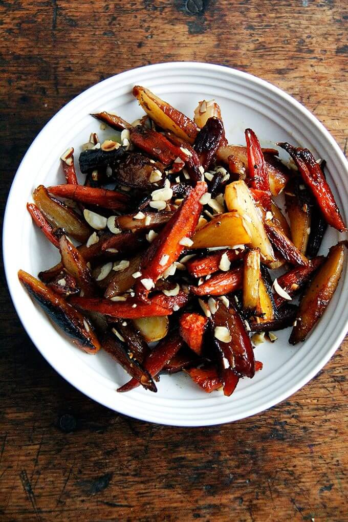 These burnt carrots with honey, black pepper, butter, and almonds are really twice-roasted carrots that bathe in vinegar after their first pass in the oven, then get dressed with butter and honey before their second. I set the finished dish on the kitchen table before running out to do errands, and while I was out, I received a text message from my husband that read: 一碗烤胡萝卜。