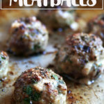 Broiled lamb meatballs on a sheet pan.